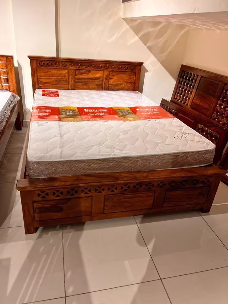 Solid sheesham wood bed in honey finish with traditional lattice work headboard design.